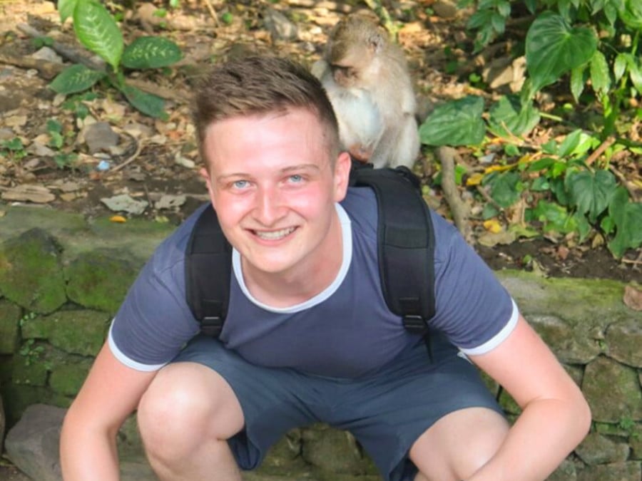 A man with a monkey on his shoulder