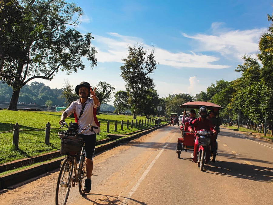 Cyclists on a Cambodian road