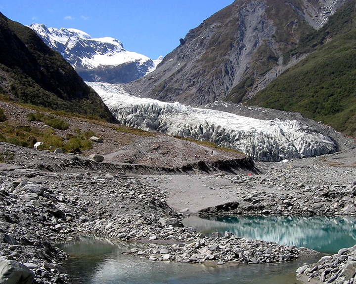 Franz Josef Glacier with blue lakes and icy mountain peaks