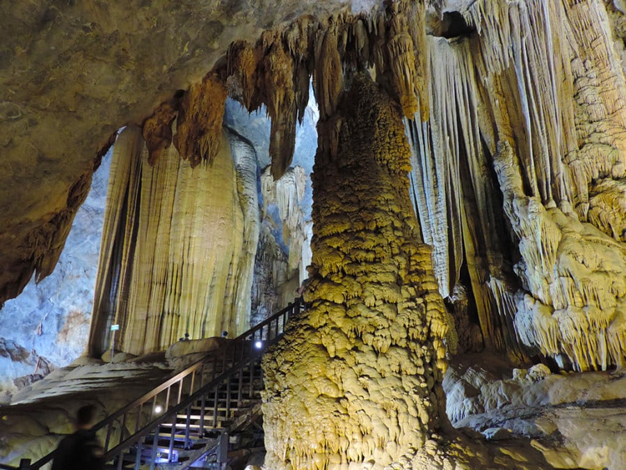 Steps leading into a cave with stalactites