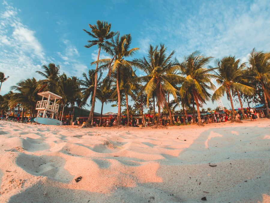 Sand and palm tress on White Beach, Boracay Island