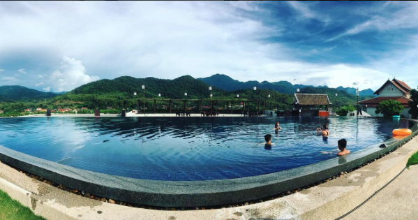 People in a pool surrounded by mountains